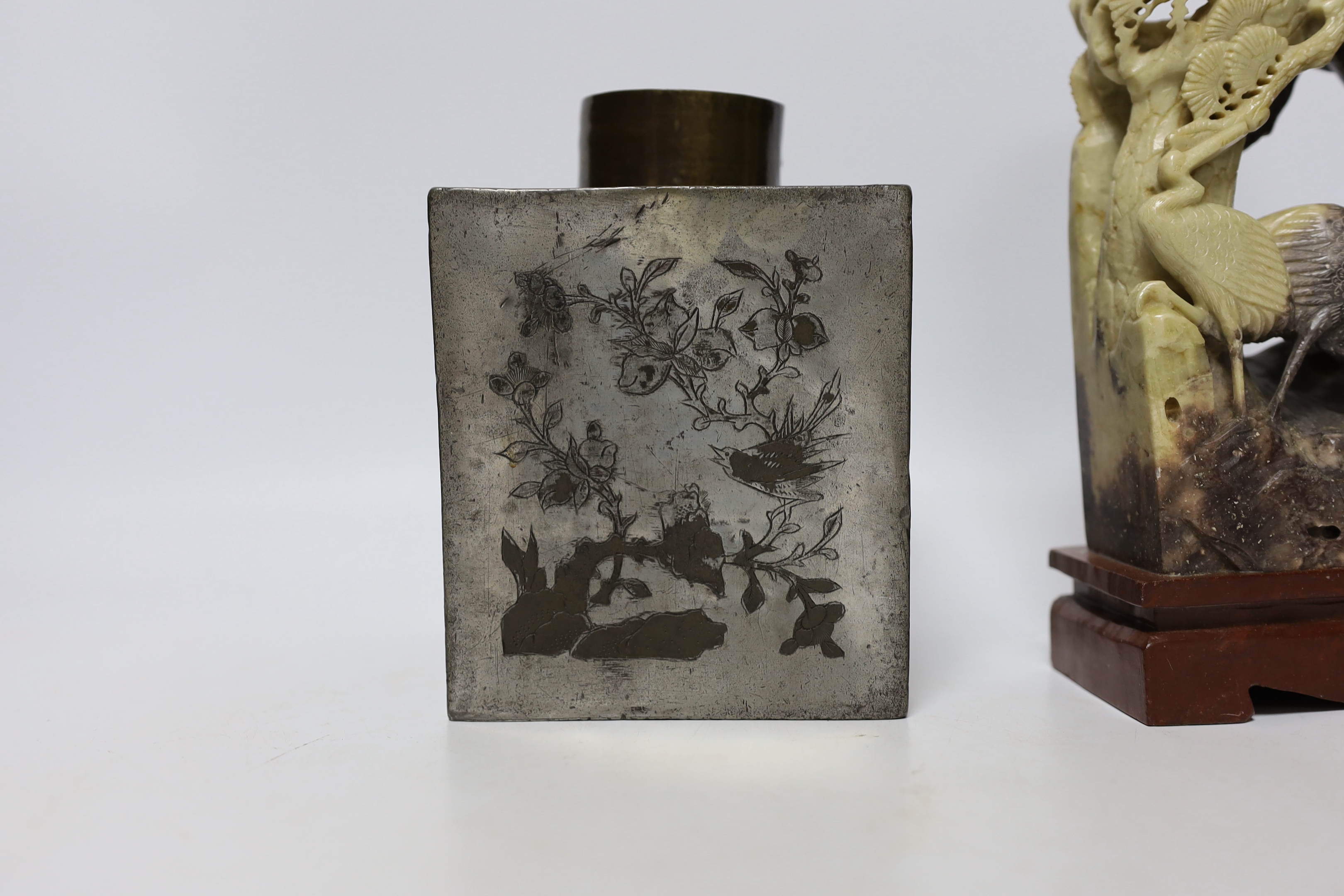 Two Chinese soapstone carvings and a pewter tea canister decorated with birds, largest 24cm high